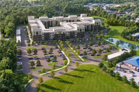 Aerial rendering of a five-storey courtyard apartment building lettered CONRAD, surrounded by a tree-lined parking lot, mown lawns and two retention ponds.